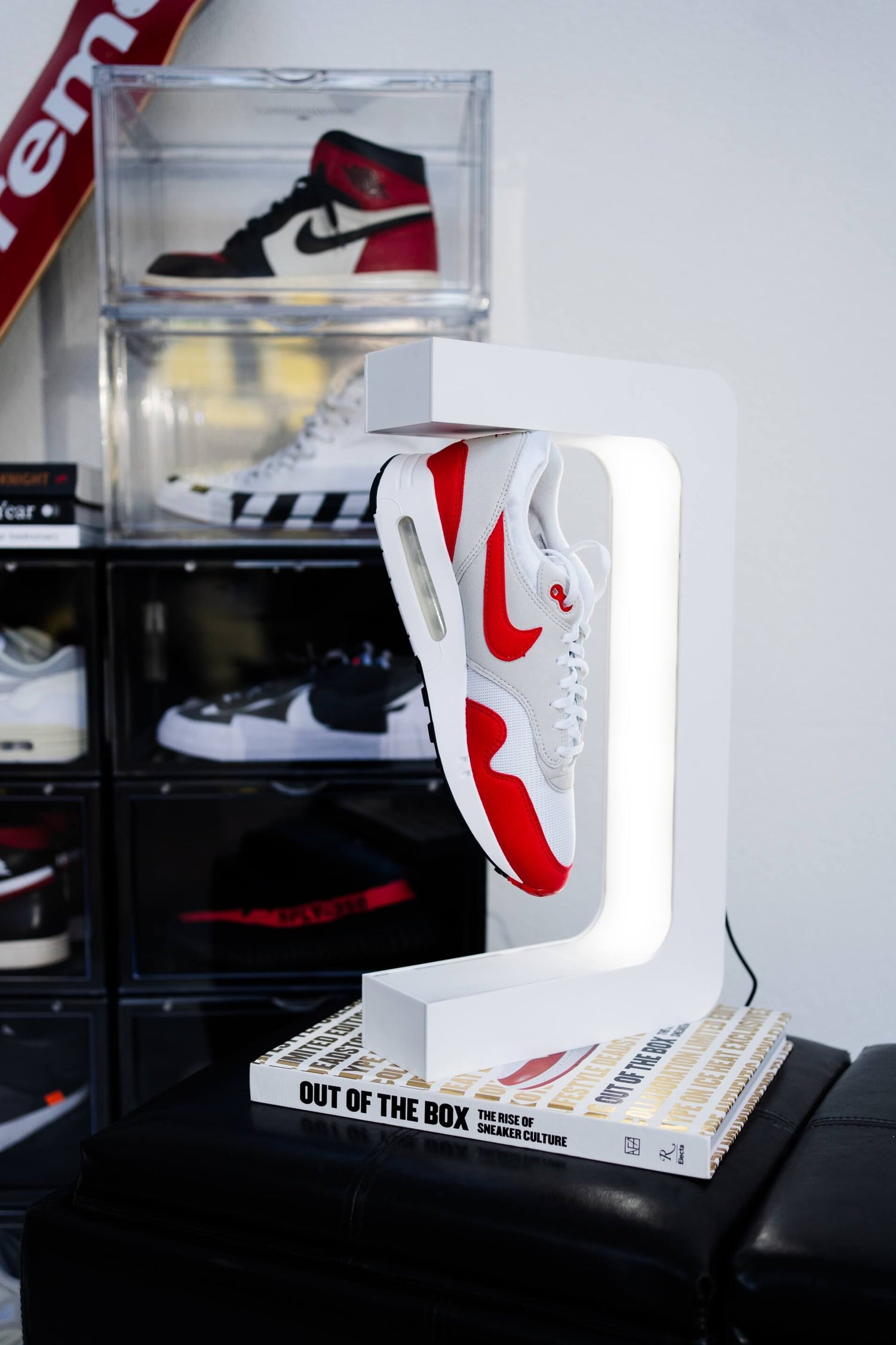 White sneaker levitating display stand and boxes